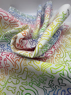 Colorful patterned fabric with penisshapes on a white background