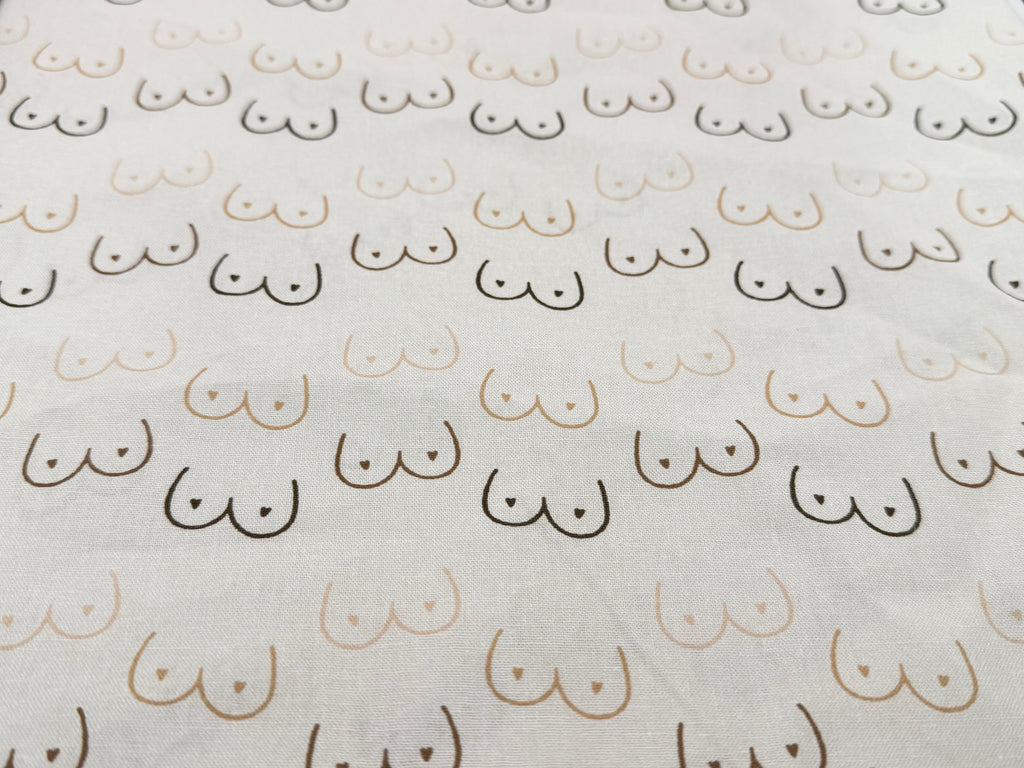 Pattern of boobies on cream cotton fabric