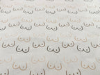 Pattern of boobies on cream cotton fabric