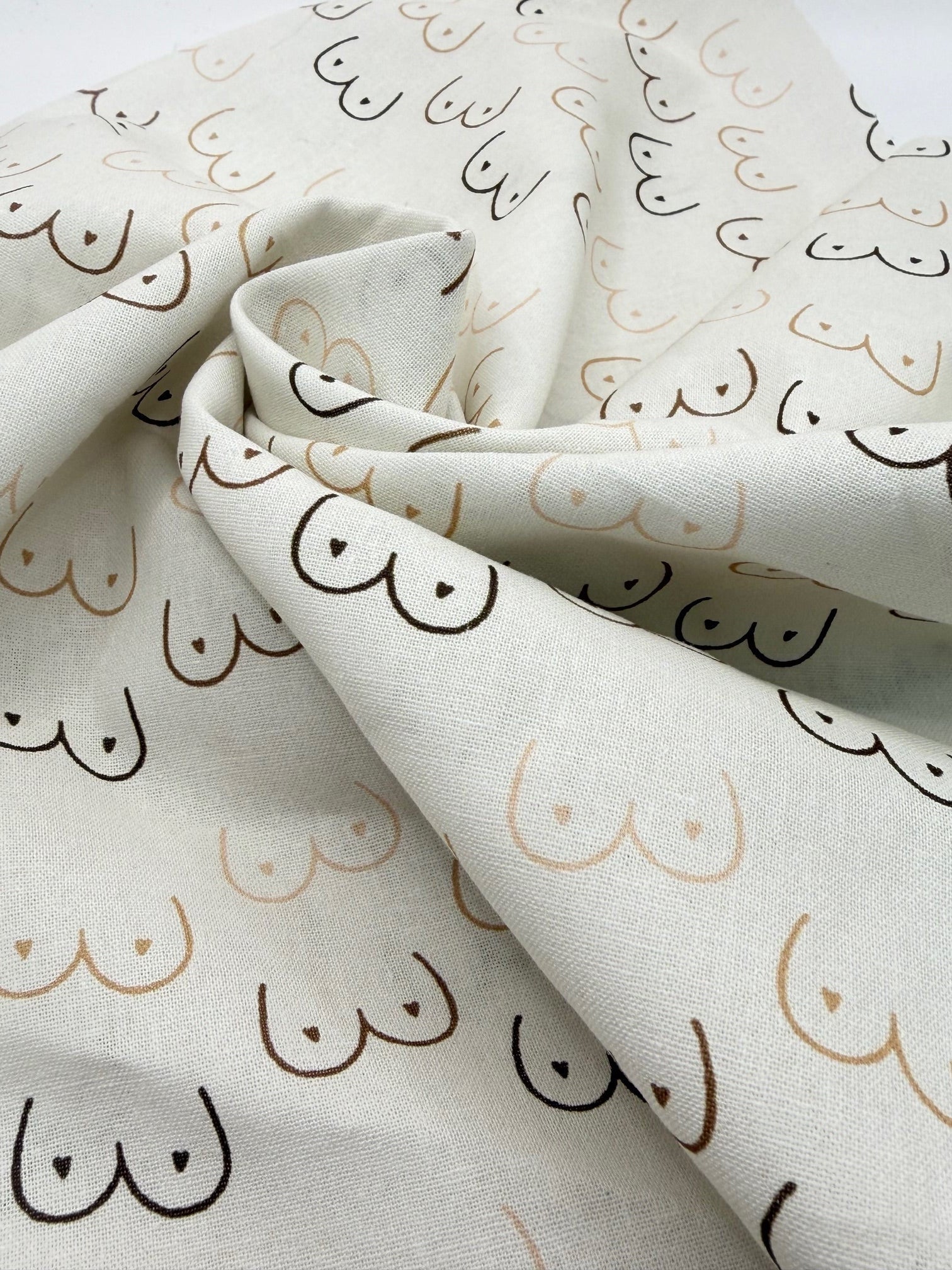 Fabric with boobs pattern on a cream background