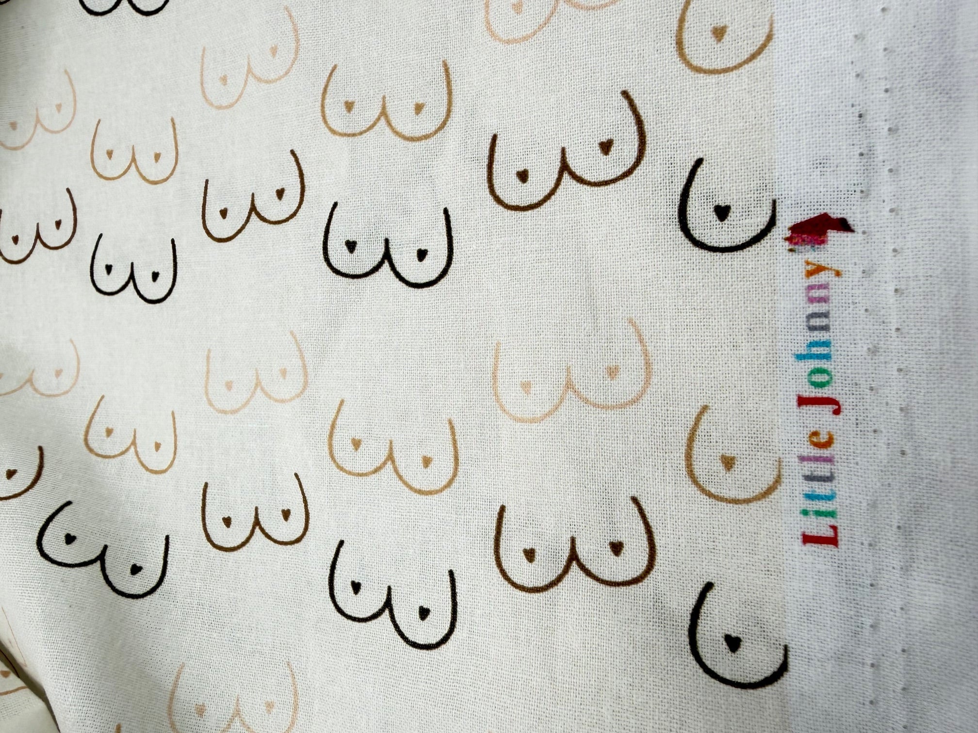 Fabric with nipple pattern and 'Little Johnny' branding.
