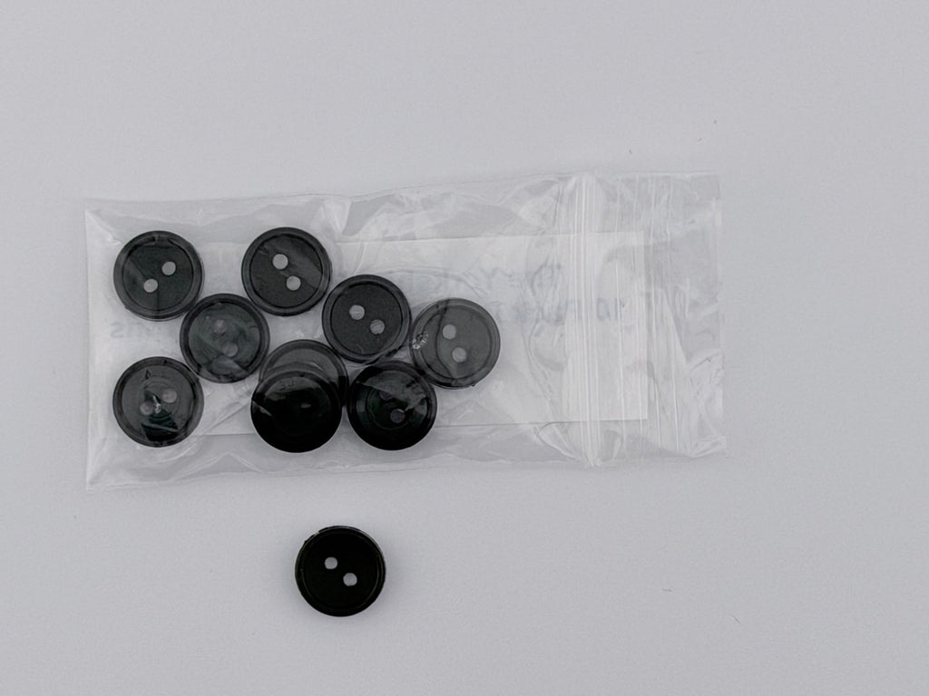 Dark Green plastic buttons, including one loose button and a clear plastic bag containing eight more, displayed on a light gray background.