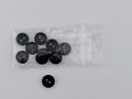 Dark Green plastic buttons, including one loose button and a clear plastic bag containing eight more, displayed on a light gray background.