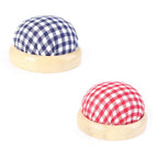 Two wooden buttons with checkered fabric covers on a white background