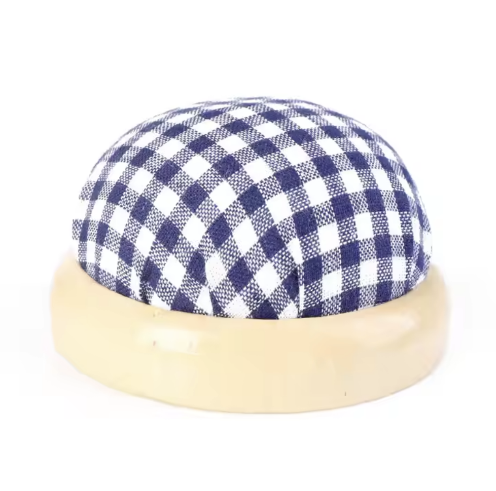 Blue and white checkered cap with beige rim on a white background